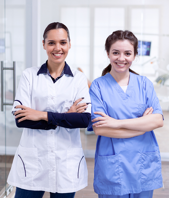happy-dentistiry-coworkers-smiling-standing-line-portrait-stomatology-team-dental-reception-with-arms-crossed-looking-camera-wearing-uniform 1